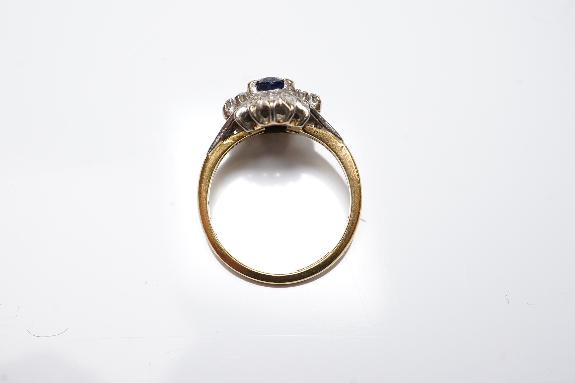 A modern 18ct gold, sapphire and diamond cluster set ring, size M/N, gross weight 4.6 grams. Condition - poor to fair